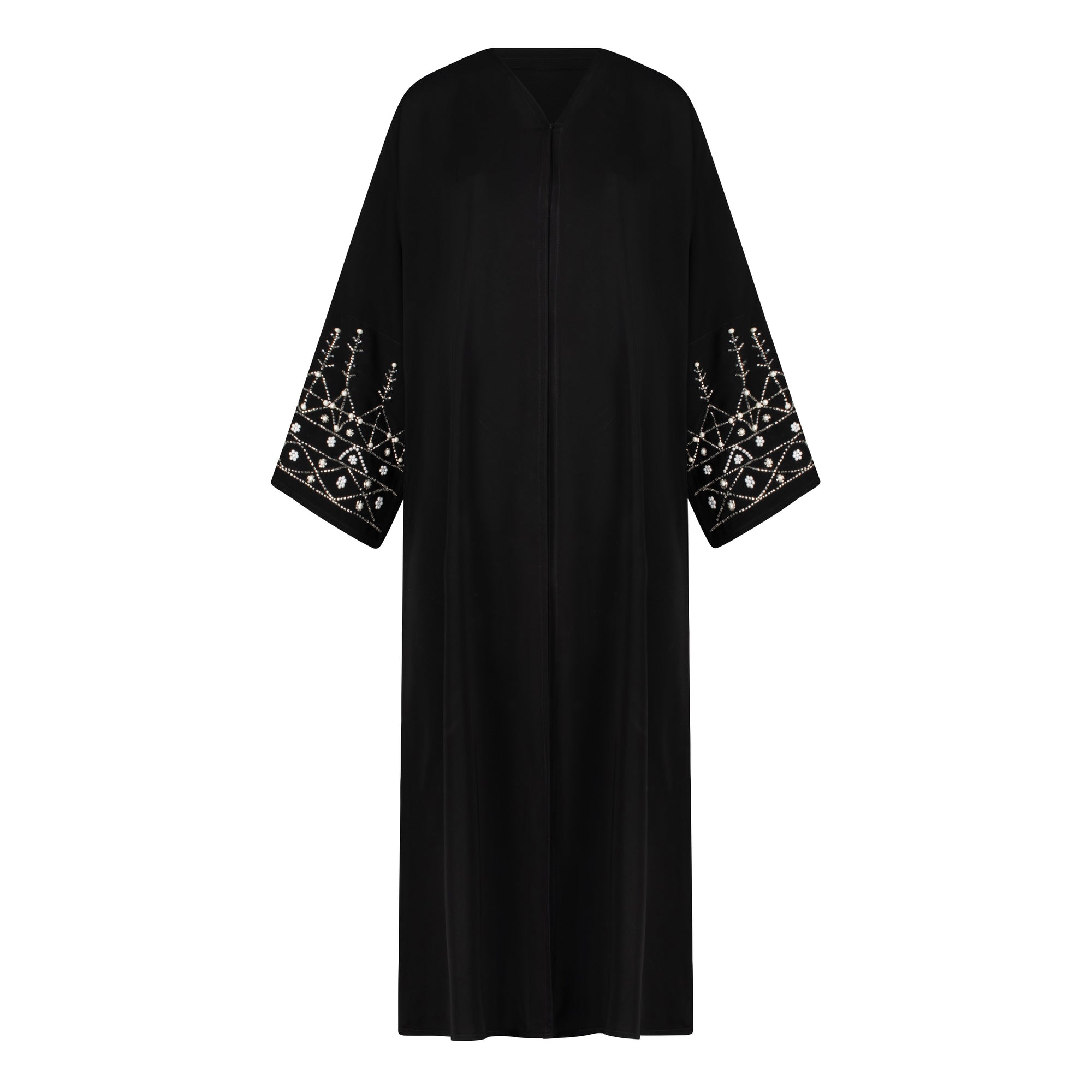 Black abaya in sizes 50-60 with hand-sewn silver and white pearl-like beadwork on the arms. Made from Zoom fabric, it features popper buttons and includes a matching black hijab. Handwash to preserve beadwork.