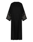 Black abaya in sizes 50-60 with hand-sewn silver and white pearl-like beadwork on the arms. Made from Zoom fabric, it features popper buttons and includes a matching black hijab. Handwash to preserve beadwork.