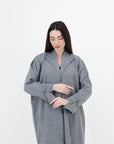 A sleek plain abaya with a collar design, available in black, grey, beige, deep green, and dark brown, crafted for elegance and comfort in sizes 50-60. Includes a complimentary hijab.