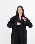 A sleek plain abaya with a collar design, available in black, grey, beige, deep green, and dark brown, crafted for elegance and comfort in sizes 50-60. Includes a complimentary hijab.