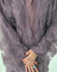 Purple floral lace garment with a plain background