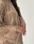 Beige lace dress with floral patterns on a white background