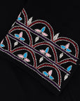 Black Liana Abaya with hand-sewn silver beads in a leaf and embroidery design pattern on the arms. Light pink, blue, and purple threads add color to the embroidery. Comes with a matching black hijab and popper buttons for closure.