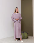 Neha Abaya available in White and Pastel Purple, with beaded floral and leafy designs on the sleeves. Made from crepe fabric with popper buttons, available in sizes 50-60. Includes a matching hijab.
