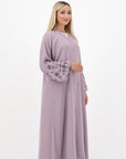 Neha Abaya available in White and Pastel Purple, with beaded floral and leafy designs on the sleeves. Made from crepe fabric with popper buttons, available in sizes 50-60. Includes a matching hijab.