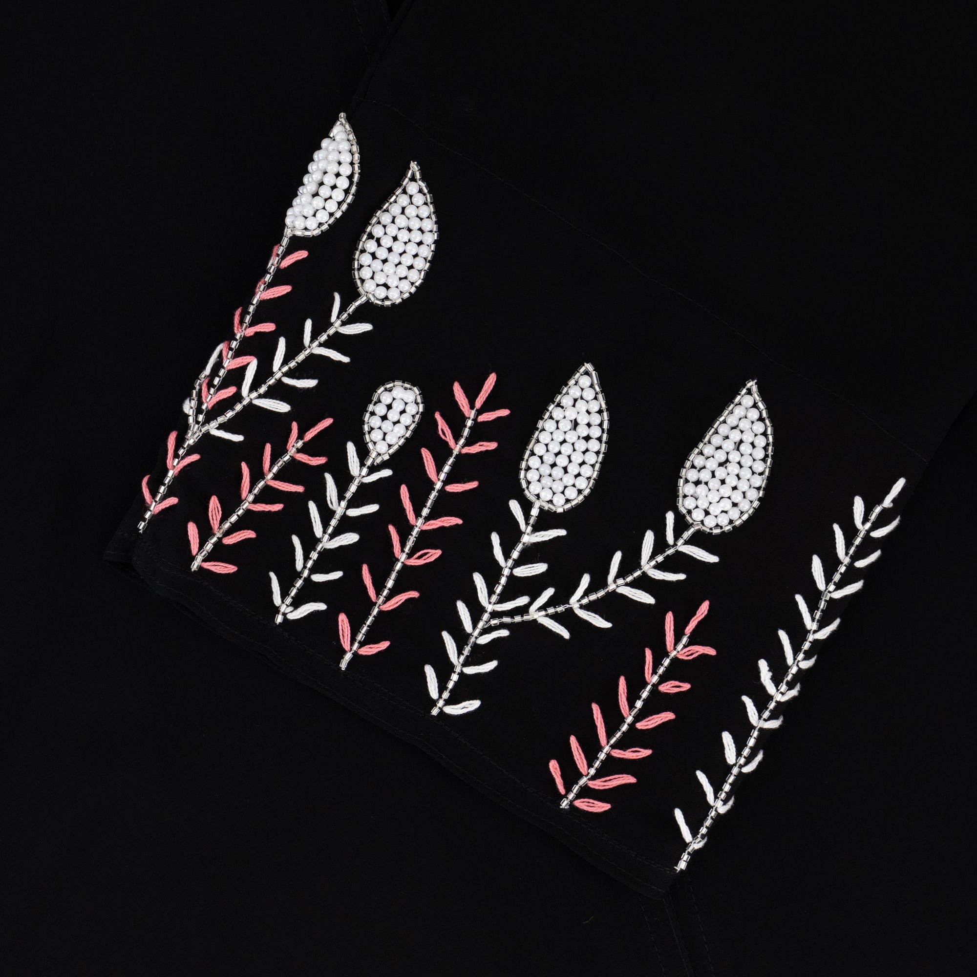 Black abaya with silver and white beadwork, pink and white leaf embroidery, Zoom fabric, popper buttons, matching black hijab, available in sizes 50-60.