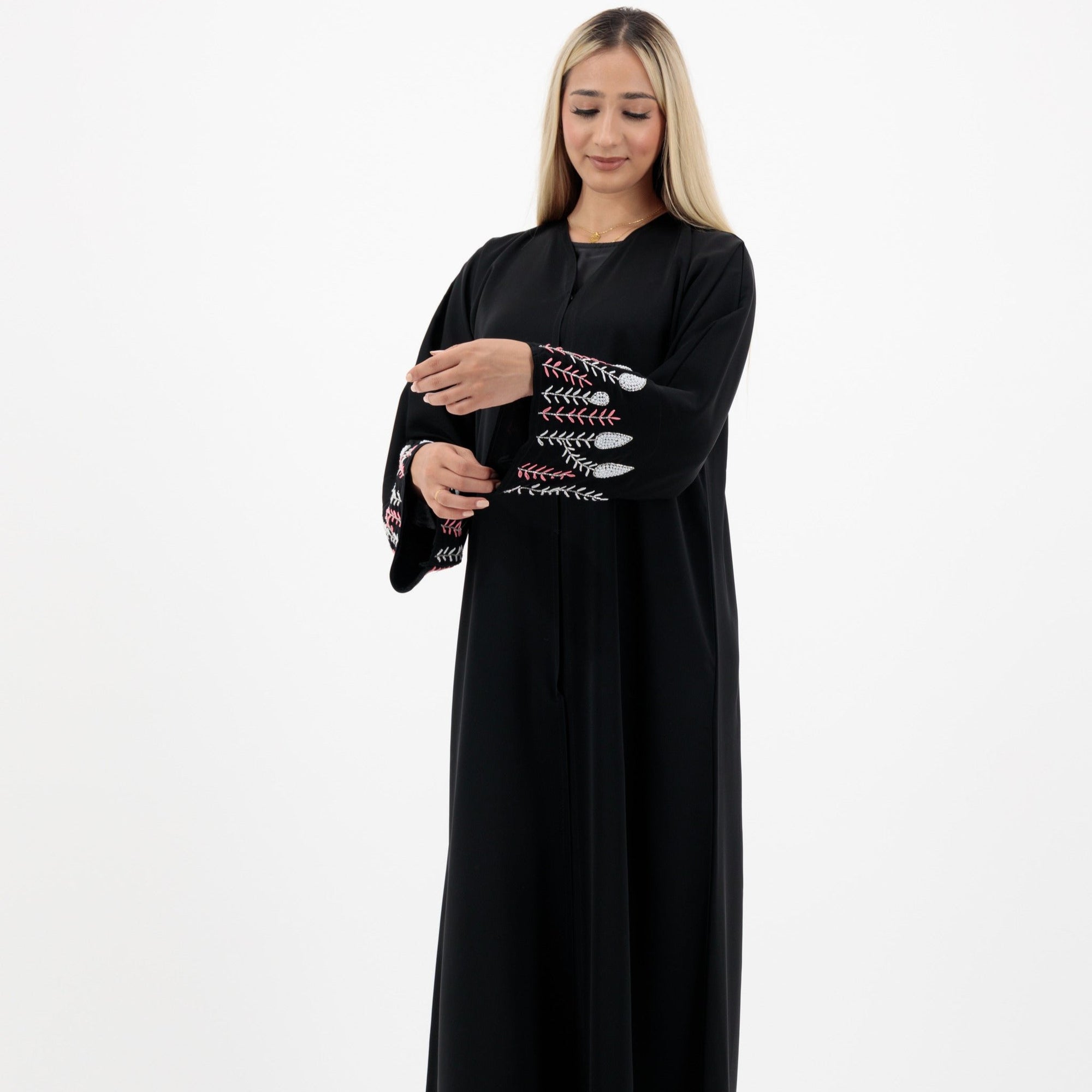 Black abaya with silver and white beadwork, pink and white leaf embroidery, Zoom fabric, popper buttons, matching black hijab, available in sizes 50-60.