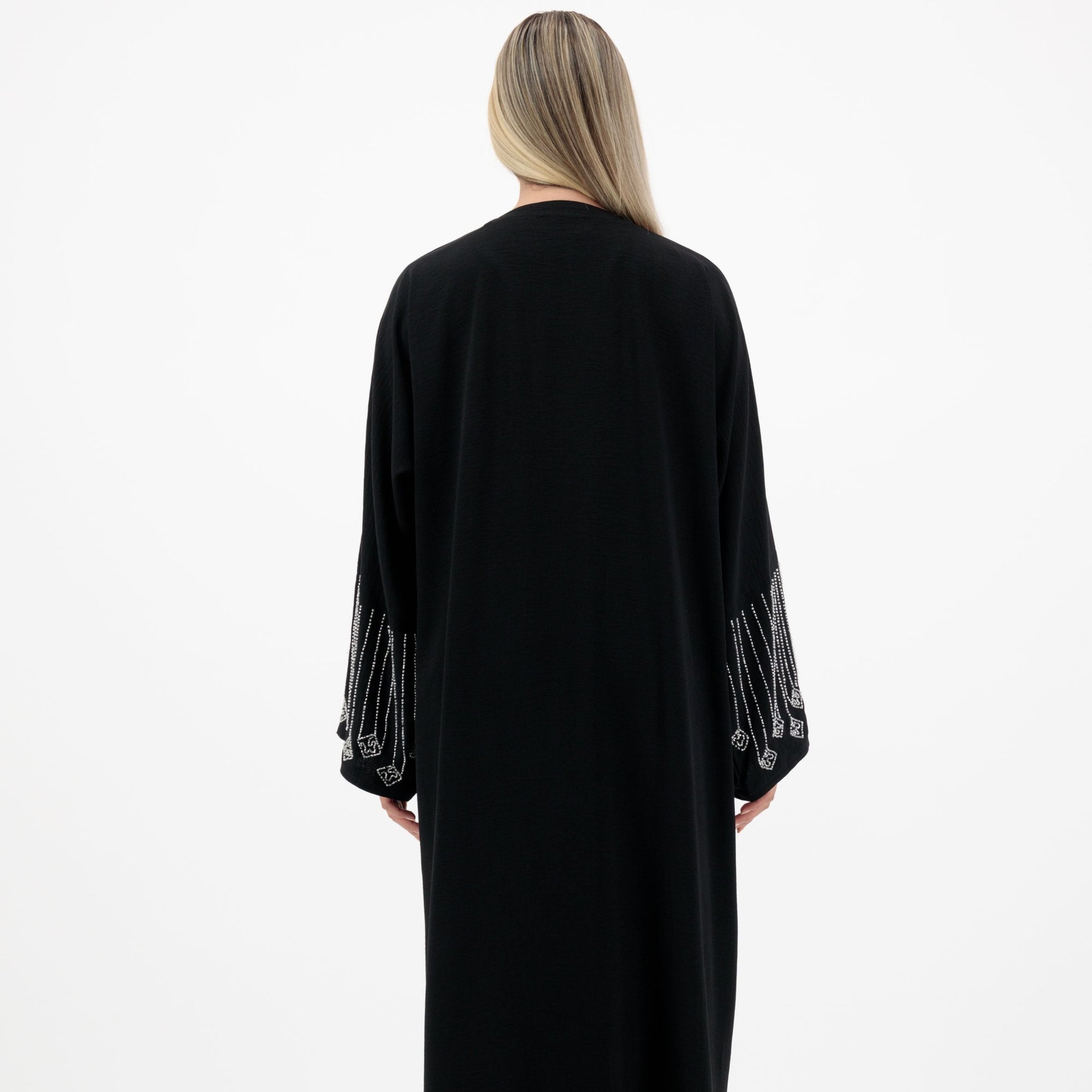 Amelia open abaya with detailed sleeves, available in sizes 52-58. Crafted from soft, flowing fabric, it offers an elegant, modest look for formal occasions, Eid celebrations, and professional events. Comfortable fit and easy-care, hand wash only.