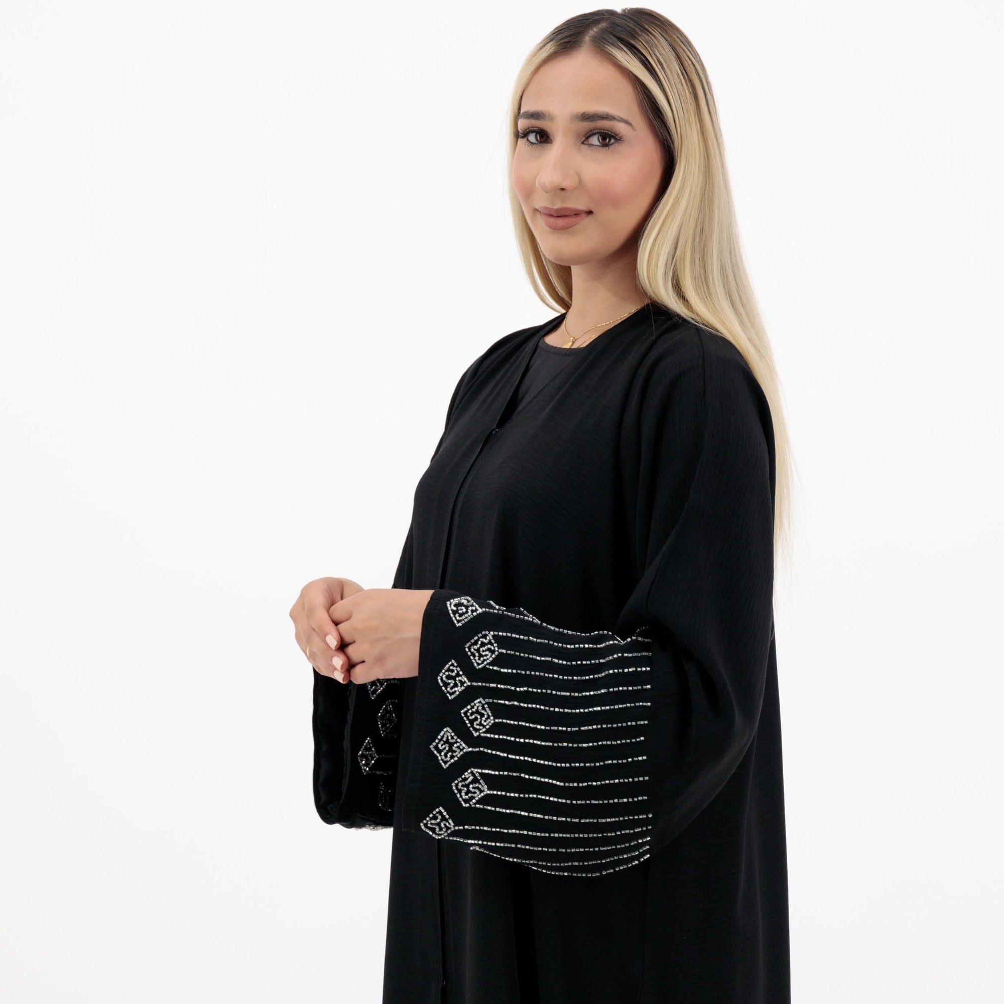 Amelia open abaya with detailed sleeves, available in sizes 52-58. Crafted from soft, flowing fabric, it offers an elegant, modest look for formal occasions, Eid celebrations, and professional events. Comfortable fit and easy-care, hand wash only.