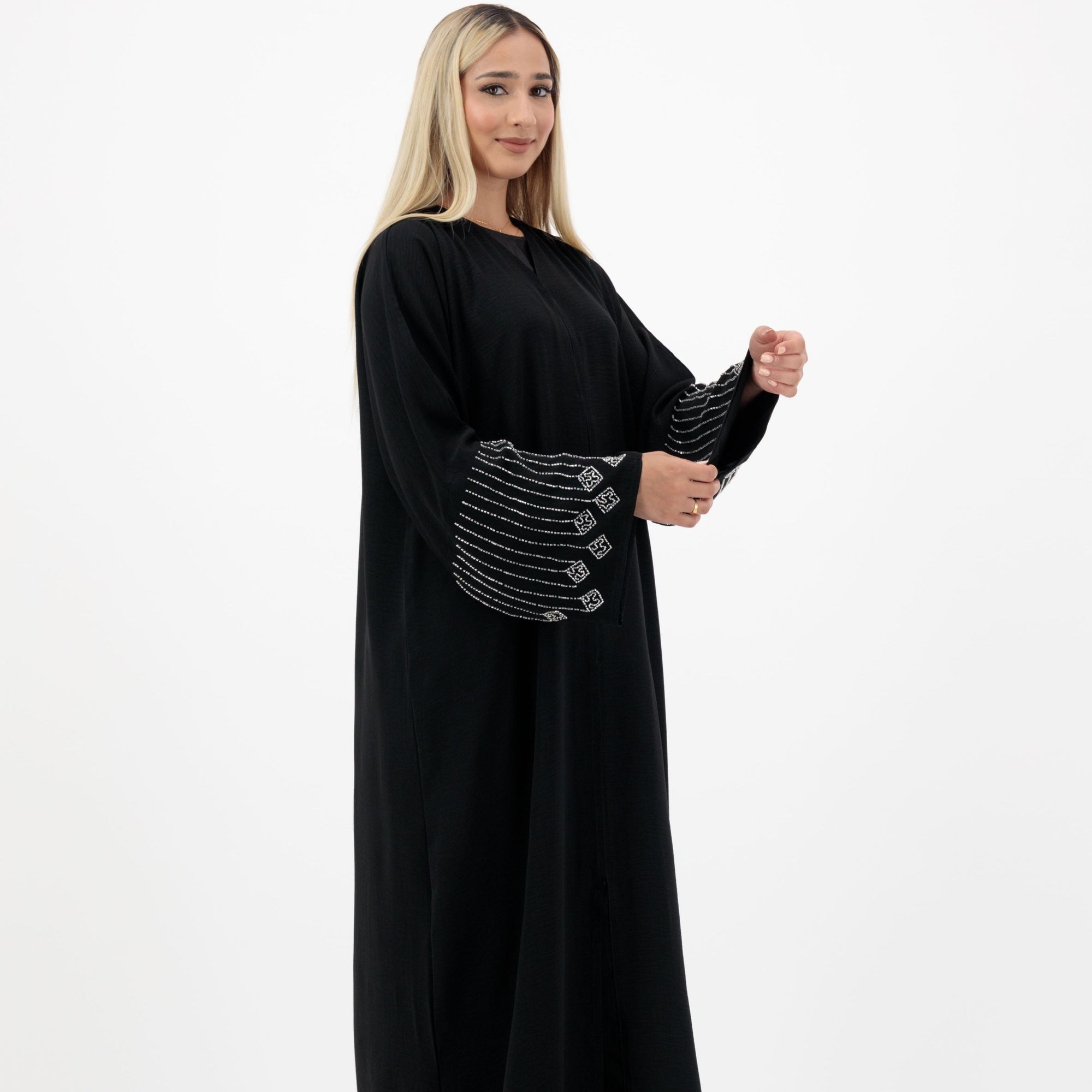 Amelia open abaya with detailed sleeves, available in sizes 52-58. Crafted from soft, flowing fabric, it offers an elegant, modest look for formal occasions, Eid celebrations, and professional events. Comfortable fit and easy-care, hand wash only.