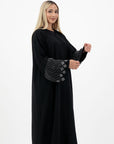 Amelia open abaya with detailed sleeves, available in sizes 52-58. Crafted from soft, flowing fabric, it offers an elegant, modest look for formal occasions, Eid celebrations, and professional events. Comfortable fit and easy-care, hand wash only.