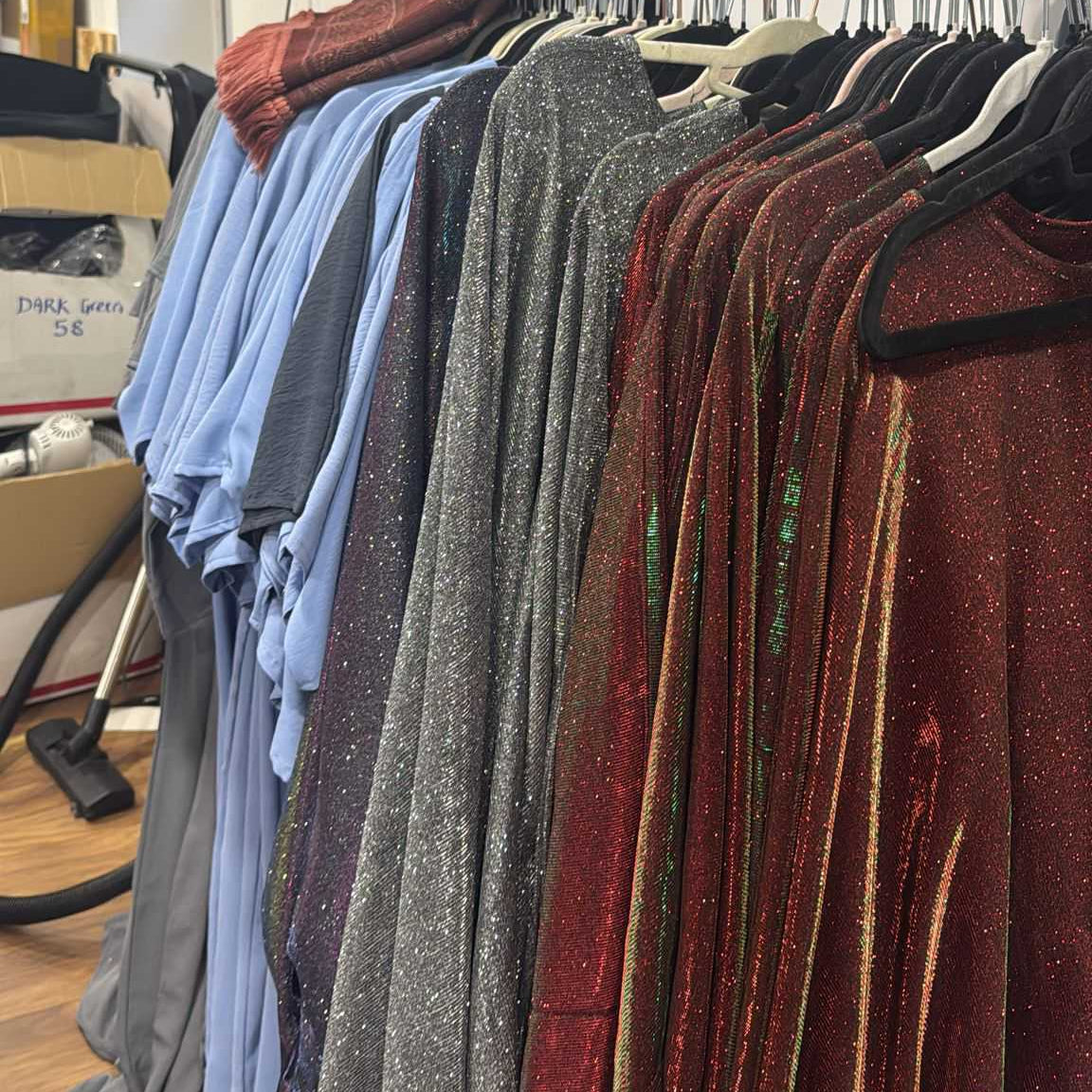 Clothing rack with various shirts in a room setting