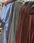 Clothing rack with various shirts in a room setting