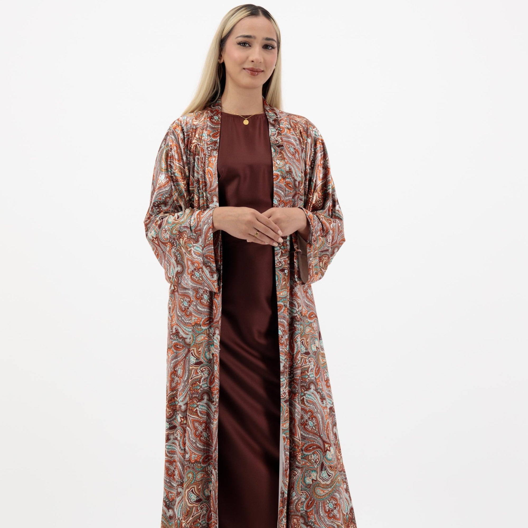 Samra Abaya available in Copper Canyon and Lunar Green, an elegant open abaya with subtle prints, popper buttons, and crafted from crepe material, available in sizes 50-60.