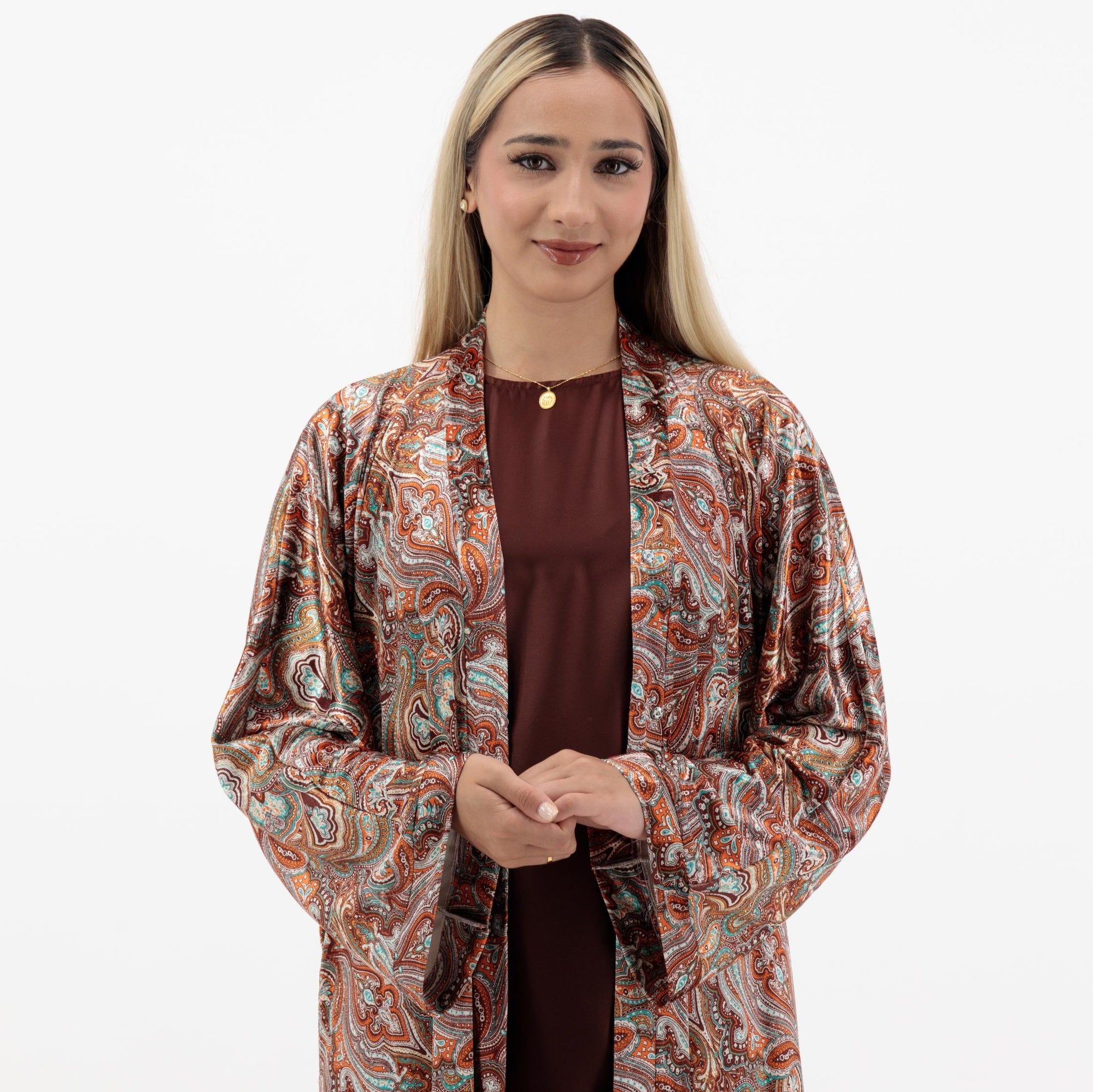 Samra Abaya available in Copper Canyon and Lunar Green, an elegant open abaya with subtle prints, popper buttons, and crafted from crepe material, available in sizes 50-60.