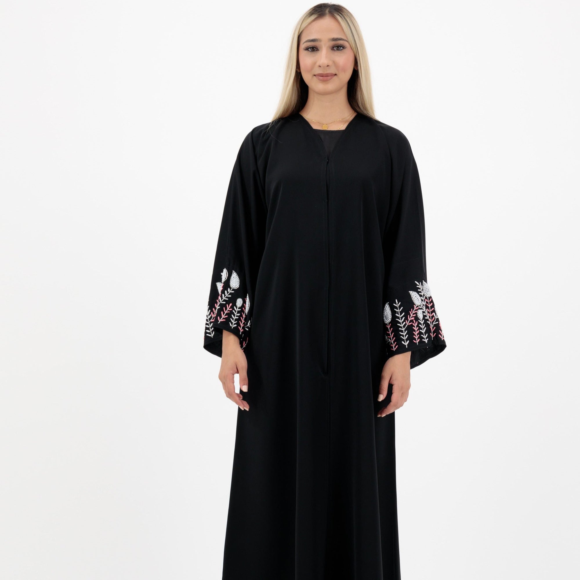 Black abaya with silver and white beadwork, pink and white leaf embroidery, Zoom fabric, popper buttons, matching black hijab, available in sizes 50-60.