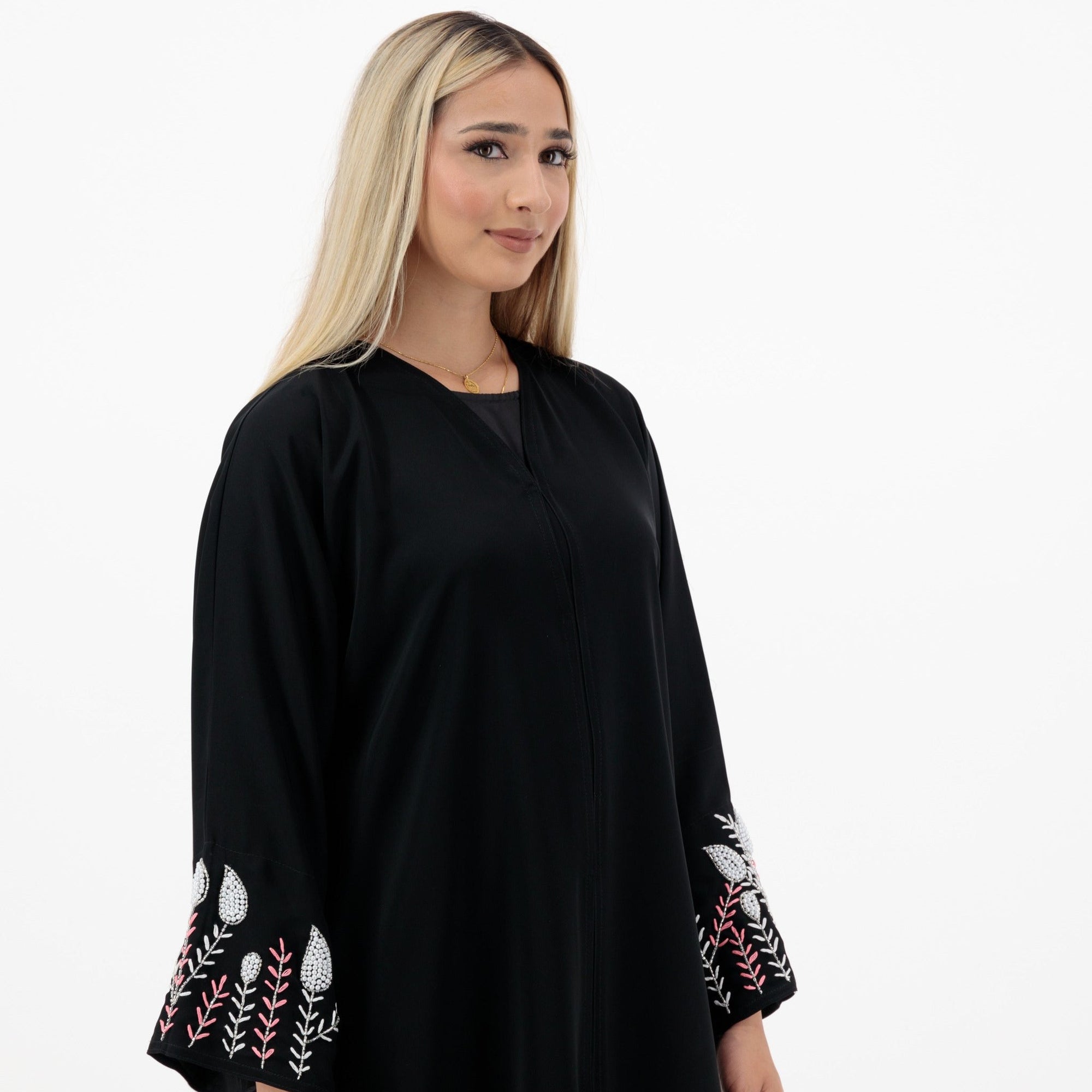 Black abaya with silver and white beadwork, pink and white leaf embroidery, Zoom fabric, popper buttons, matching black hijab, available in sizes 50-60.