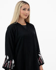 Black abaya with silver and white beadwork, pink and white leaf embroidery, Zoom fabric, popper buttons, matching black hijab, available in sizes 50-60.