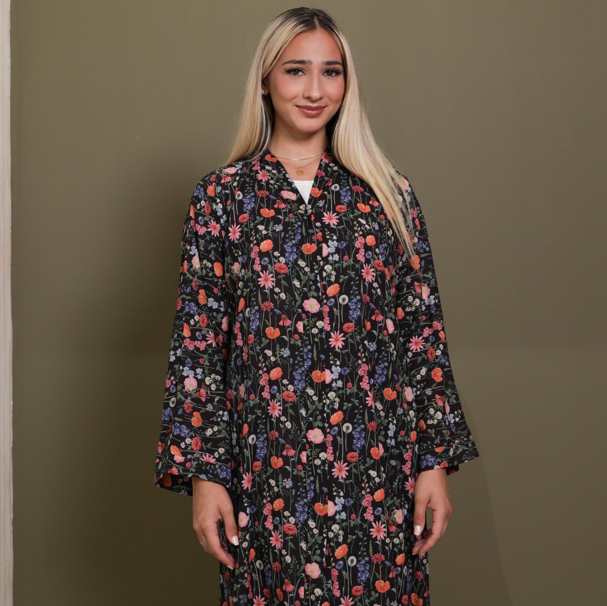 Wardah Abaya available in Black, Moon Mist, and Gum Leaf, featuring delicate floral prints, popper buttons, and made from crepe fabric, available in sizes 50-60.